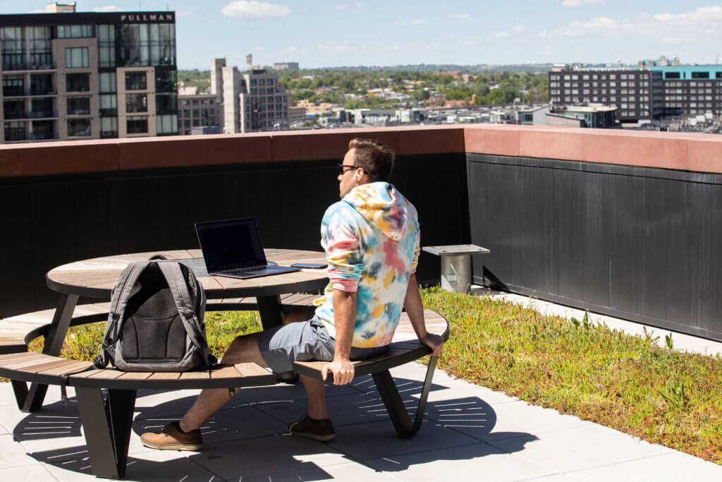 A Red Canary employee takes a moment on the roof deck at at our company headquarters in downtown Denver.