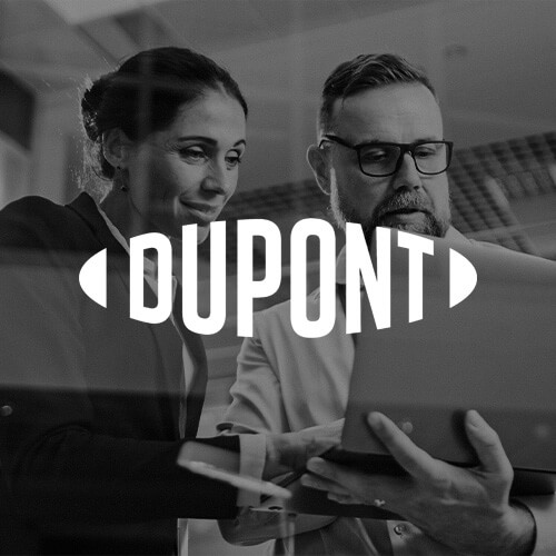 Woman and man looking at a computer with DuPont logo overlaid